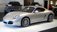 a silver sports car is on display in a showroom