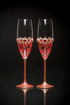 two red wine glasses sitting next to each other