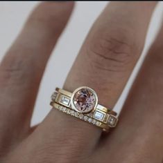 a woman's hand with two rings on it