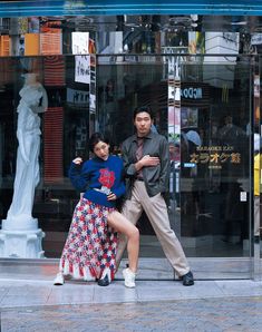 a man and woman dancing in front of a store