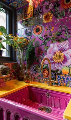 a colorful kitchen with flowers painted on the wall and sink in front of an open window