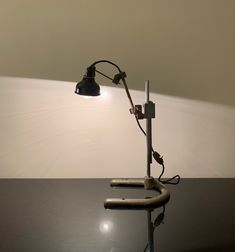 a desk lamp sitting on top of a black table