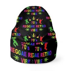 a beanie hat with the words reggae written in rainbow colors on it and an image of a man dancing