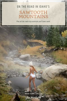 a woman in a white bathing suit standing on rocks next to a river