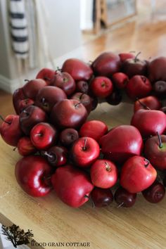 a wreath made out of cherries on a table