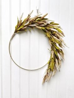 a wreath made out of dried grass hanging on a wall