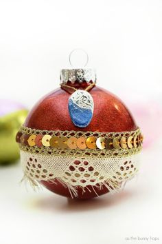 a red ornament sitting on top of a white table next to some bananas