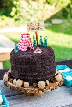 there is a cake on the table with a sign that says camp ruta - muk