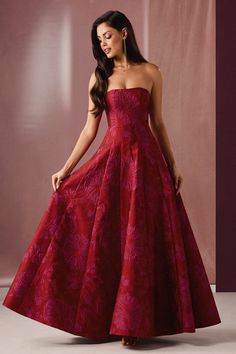 The Mimmy Gown will ensure you stand out from the crowd at your next formal function. This beautiful floral brocade number features a romantic strapless neckline and a voluminous floor-length A-line skirt. Wear this beauty to a red carpet event, gala, or your next special occasion. Red Formal Ball Gown, Dark Floral Prom Dress, Red Prom Dresses Poofy, Red Prom Dresses Long Elegant Classy, Hot Pink Formal Dresses, Red Prom Dresses Long Elegant, Champagne Problems Aesthetic, Hot Pink Gown, Wedding Guest Fits