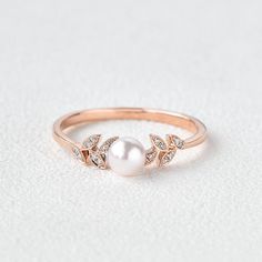 Felicegals 5mm Akoya Pearl Engagement Ring 0.06ct Moissanite Rose Gold Ring Art Deco Leafy Ring 14k solid rose gold band Natural Akoya Pearl, 5mm Colourless Moissanite Accents The moissanite accents version features VS to VVS clarity. 0.06ct total carat weight 1.5mm bandwidth ** This item is specially made for you. Please allow 2-3 weeks lead time. Rose Gold Pearl Engagement Ring, Pearl Rose Gold Ring, Silver Pearl Ring For Women, Pearl Rings In Gold, Gold Pearl Rings, Pearl Promise Rings, Pearl Ring Design, Pearl Wedding Ring, June Birthstone Ring