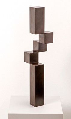 a sculpture is shown on top of a white platform and it appears to be made out of metal cubes