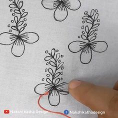 someone is stitching flowers on the fabric