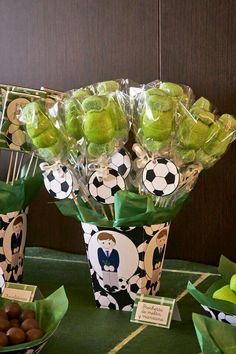 a table topped with green candies and soccer balls