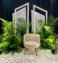 a chair sitting in front of two mirrors with plants around it on either side of the room