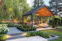 an outdoor living area with seating and landscaping