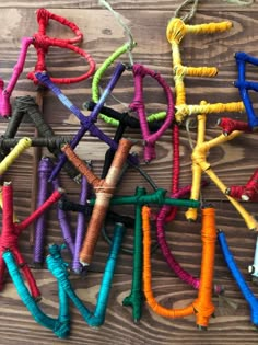 several different colored ropes are laid out on a wooden surface with strings attached to them