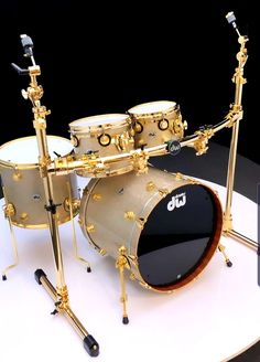 a gold drum set is sitting on a white table