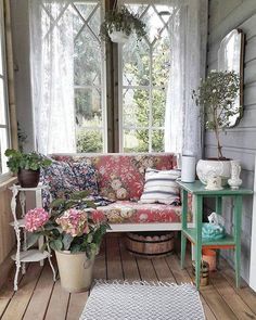 a living room filled with lots of furniture and flowers on top of a wooden floor