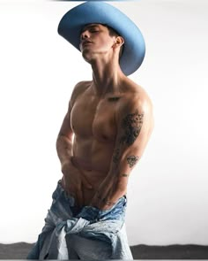 a shirtless man with a cowboy hat on his head