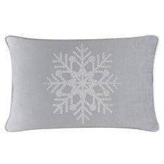 a grey pillow with white snowflakes on it