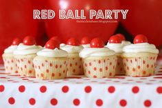 red ball party cupcakes with white frosting and cherries