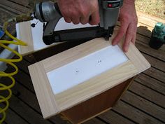 a person using a power tool to cut out a piece of wood with a jig saw