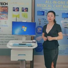 a woman standing in front of a medical cart