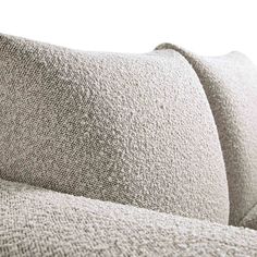 a close up view of the back of a couch with two pillows on top of it