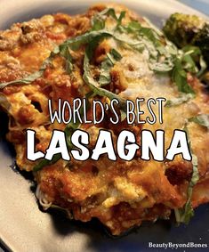 the words world's best lasagna on a plate with broccoli