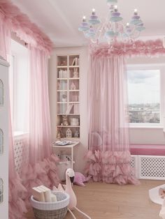 a room with pink curtains and furniture in it