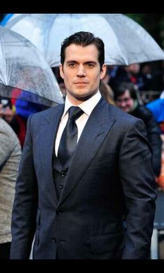 a man in a suit and tie with an umbrella