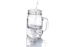 a glass jar filled with water on top of a table