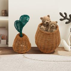 two teddy bears sitting in a basket on the floor