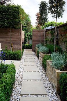 an outdoor garden with stone walkways and trees