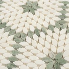 a white and green mosaic tile pattern with leaves on the bottom, in shades of gray