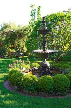 a fountain in the middle of a garden