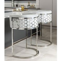 two white marble tables in a modern kitchen