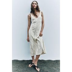 V-Neck Midi Dress With Wide Straps. Textured Fabric Detail. A-Line Silhouette. Beige V-neck Sleeveless Dress For Vacation, Beige V-neck Sleeveless Summer Dress, Beige V-neck Sundress For Day Out, Elegant Beige V-neck Dress For Day Out, Elegant Beige Sleeveless Dress For Vacation, Cream V-neck Sundress For Spring, Cream V-neck Sundress For Day Out, Beige V-neck Dress For Summer Brunch, Beige V-neck Dress For Summer Beach