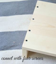 a wooden table sitting on top of a striped rug