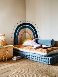 a room with a bed, stuffed animal and other items on the floor