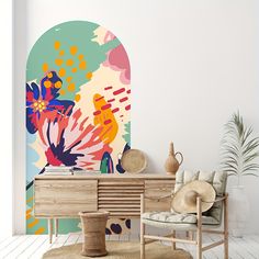 a living room with a large painting on the wall next to a chair and table