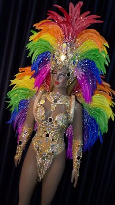 a woman in a bodysuit with colorful feathers on it's head and legs