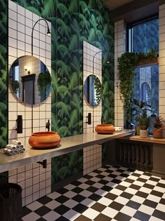 a bathroom with black and white checkered flooring, two round mirrors on the wall