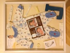 a baby's first christmas gift is displayed in a shadow box