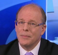 a man in a suit and tie is on the set of an abc news program