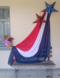 an american flag draped over a bench in front of a window