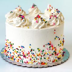 a cake with white frosting and sprinkles