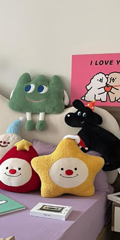 several stuffed animals are sitting on a bed