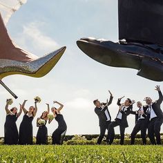 a group of people dressed in formal wear and high heels jumping up into the air