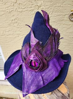 This is a wool blend  blue witchy hat with purple leather. Washing Instructions: Spot clean or wash in cold water. Yes, leather can get wet Just hand wash and air dry. The leather on the hat is soft purple deerskin. With hand painted designer cow for added effect. I also put a dragon eye on the front that is removable. The hat will fit a head size of 22 to 23 inches. Wire in the brim for shaping. This is not a hat I will carry often but sometimes it is easier to just go with the flow.  I made a Witchy Hat, Just Go With The Flow, Make A Dragon, Go With The Flow, Dragon Eye, Soft Purple, Deer Skin, Costume Hats, Purple Leather